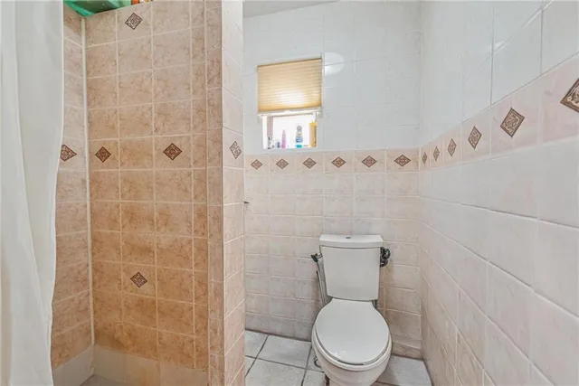 a white toilet sitting next to a bathroom sink