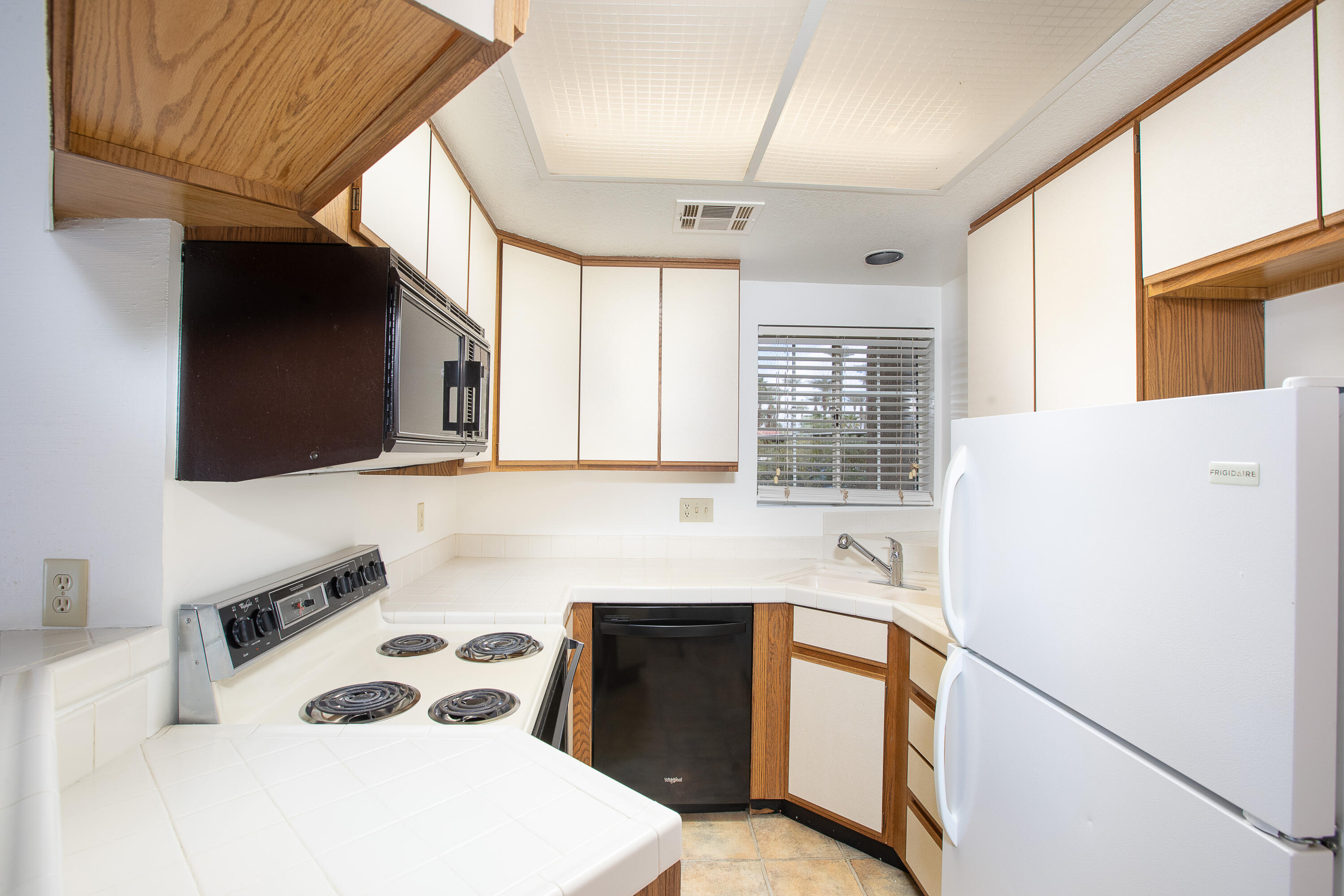 2700 Lawrence Crossley Road, Unit 27 Palm Springs, CA 92264 - Photo 2 of 13 a kitchen with a refrigerator a stove a sink and a cabinets