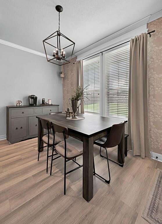 550 Hunton Lane Robinson, TX 76706 - Photo 13 of 35 Dining area featuring crown molding, a chandelier, and light wood-type flooring