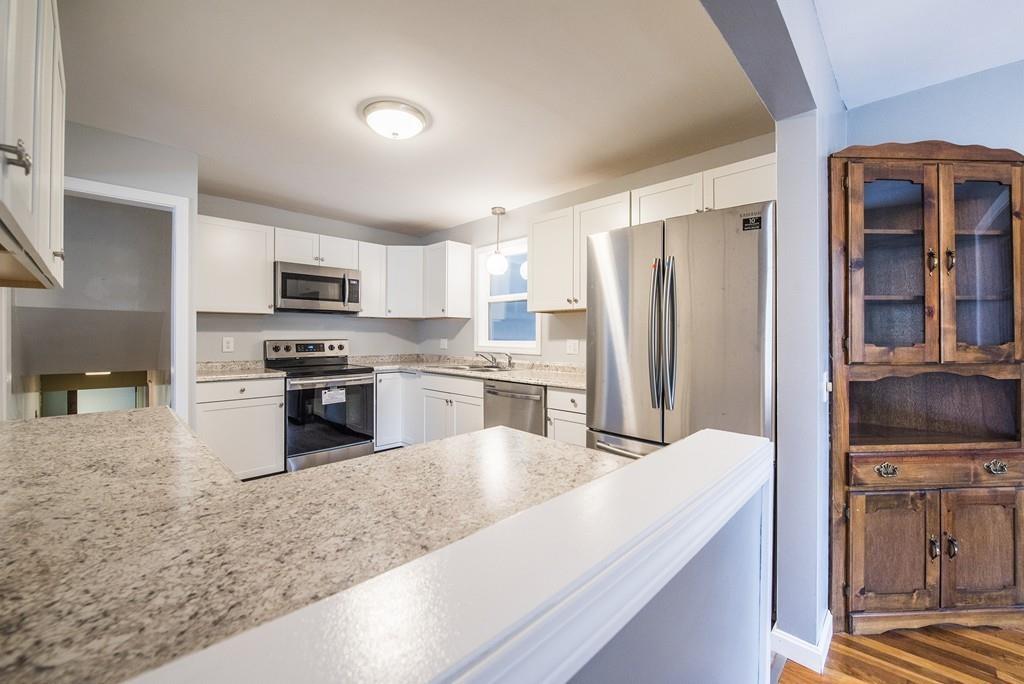 58 Old Gilbertville Road Ware, MA 01082 - Photo 8 of 32 a kitchen with stainless steel appliances granite countertop a refrigerator a stove and a sink