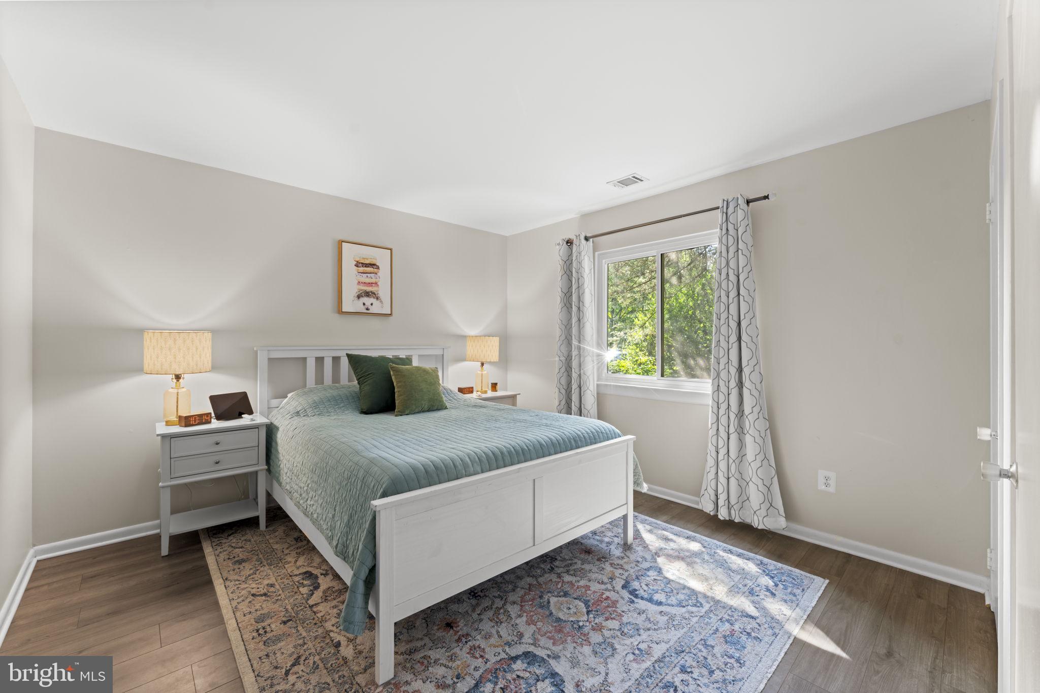 11308 Gatesborough Lane Reston, VA 20191 - Photo 24 of 58 a bedroom with a large bed and a window