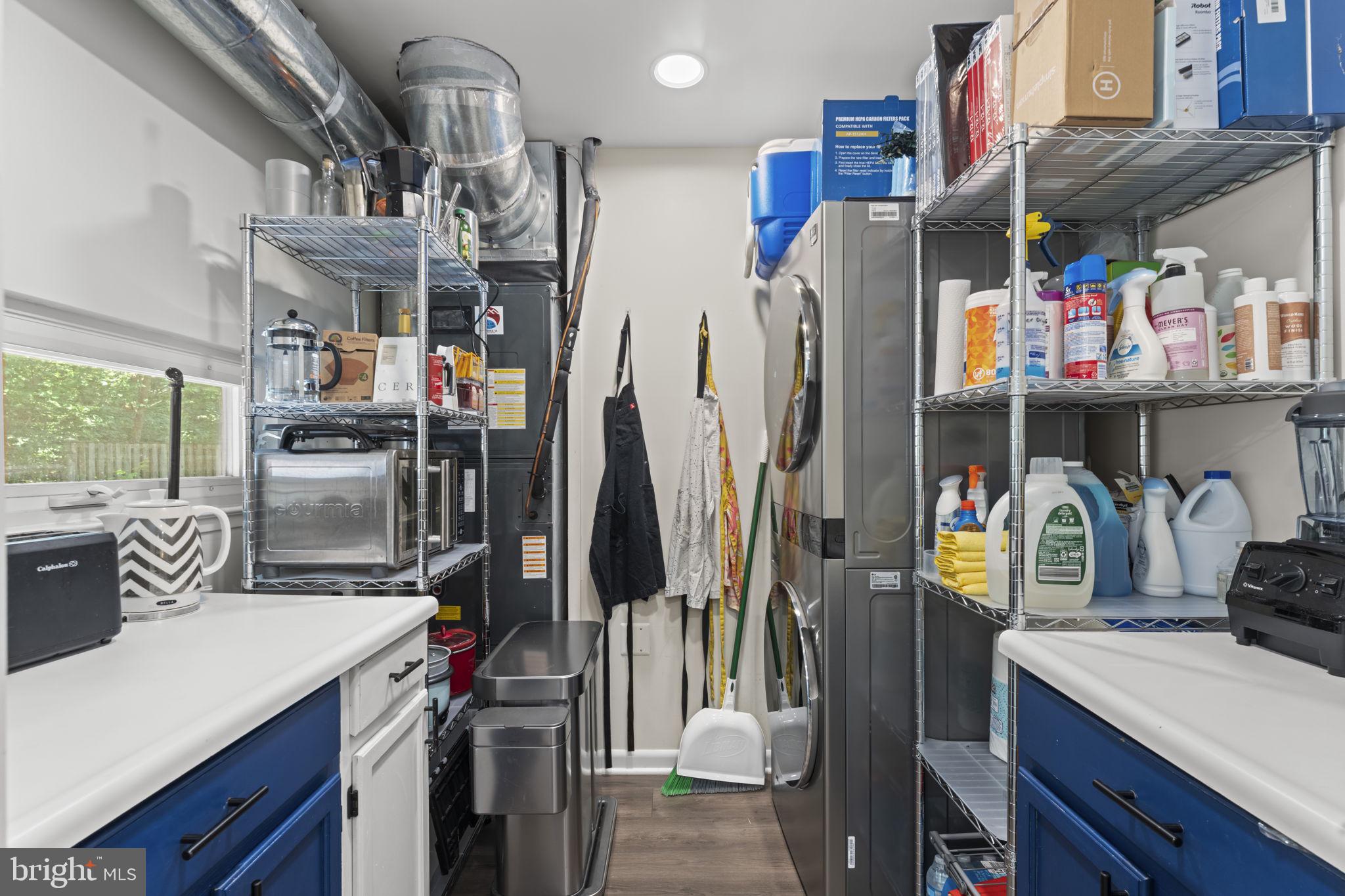 11308 Gatesborough Lane Reston, VA 20191 - Photo 27 of 58 a kitchen with stainless steel appliances a sink a refrigerator and a wooden floor