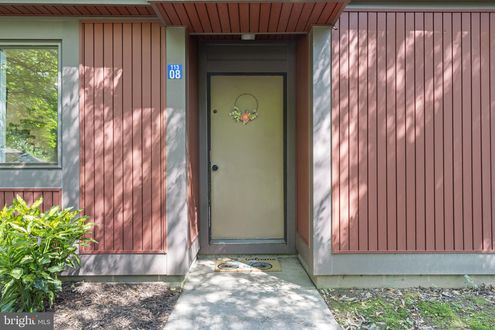 11308 Gatesborough Lane Reston, VA 20191 - Photo 4 of 58 a front view of a house with a garden