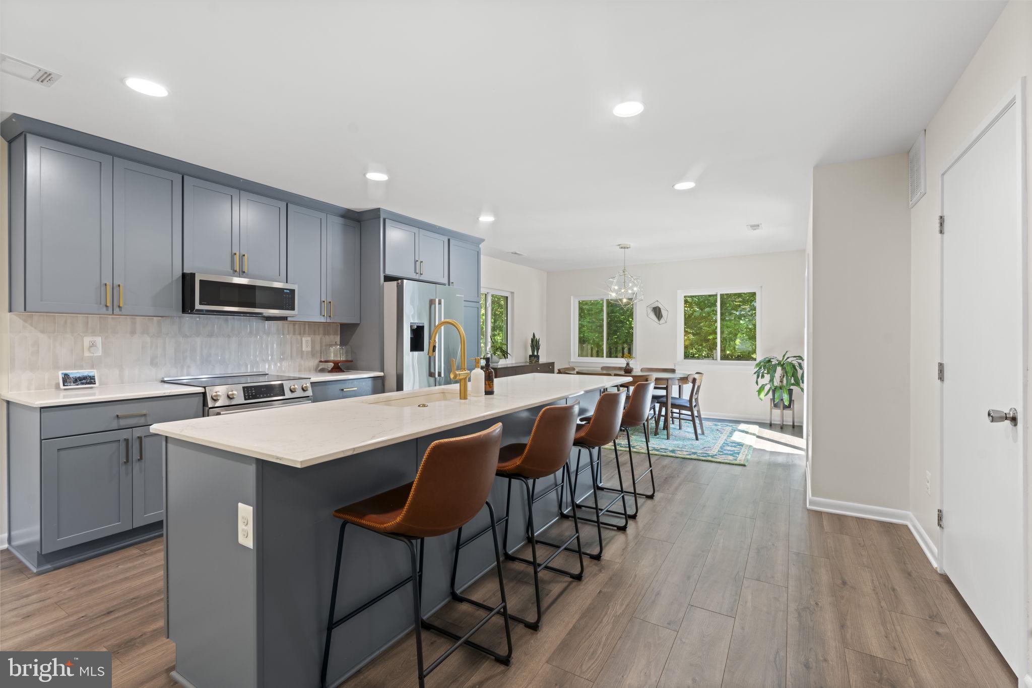 11308 Gatesborough Lane Reston, VA 20191 - Photo 7 of 58 a kitchen with appliances a sink a counter top space and cabinets