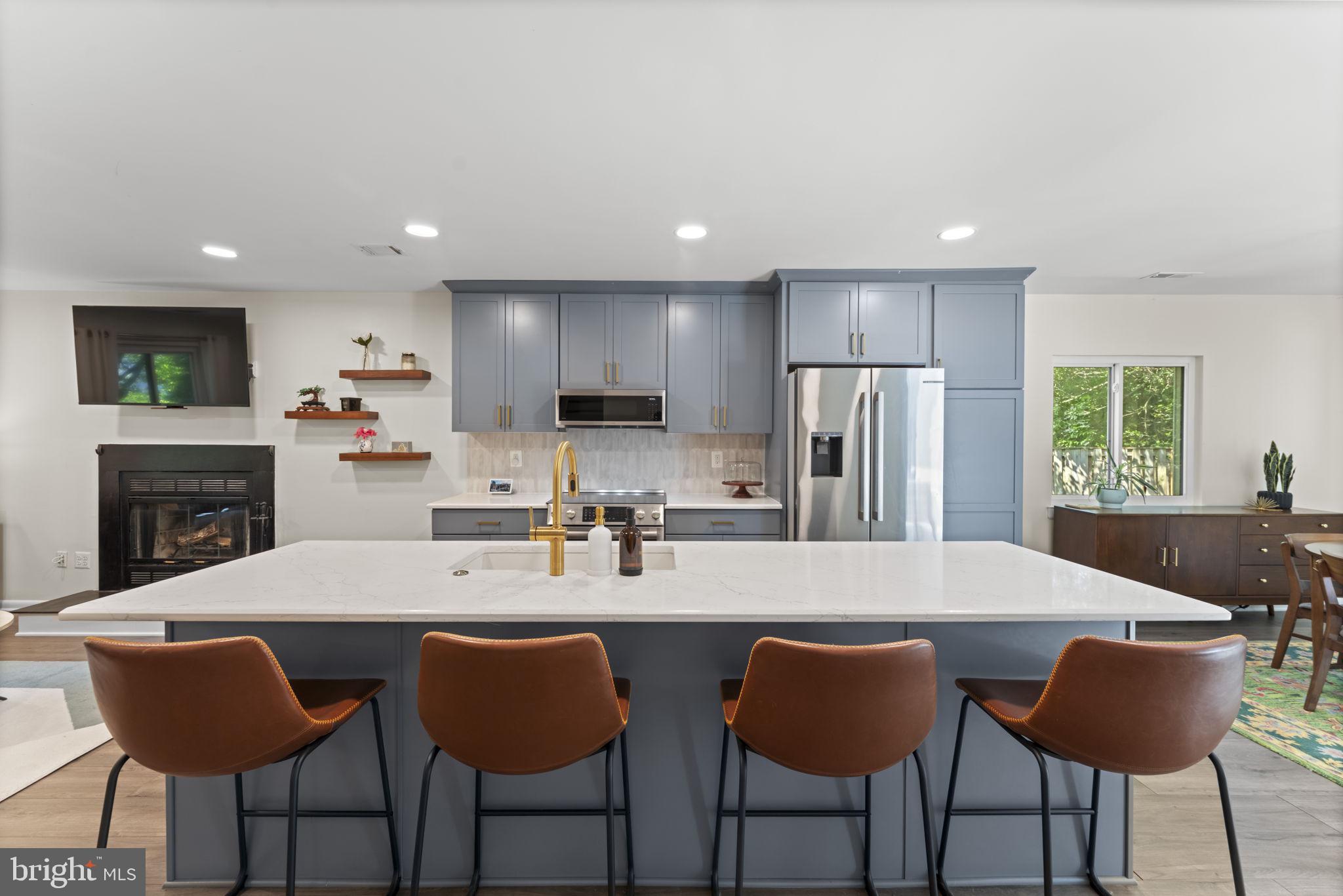 11308 Gatesborough Lane Reston, VA 20191 - Photo 8 of 58 a kitchen with stainless steel appliances granite countertop a dining table chairs refrigerator and sink