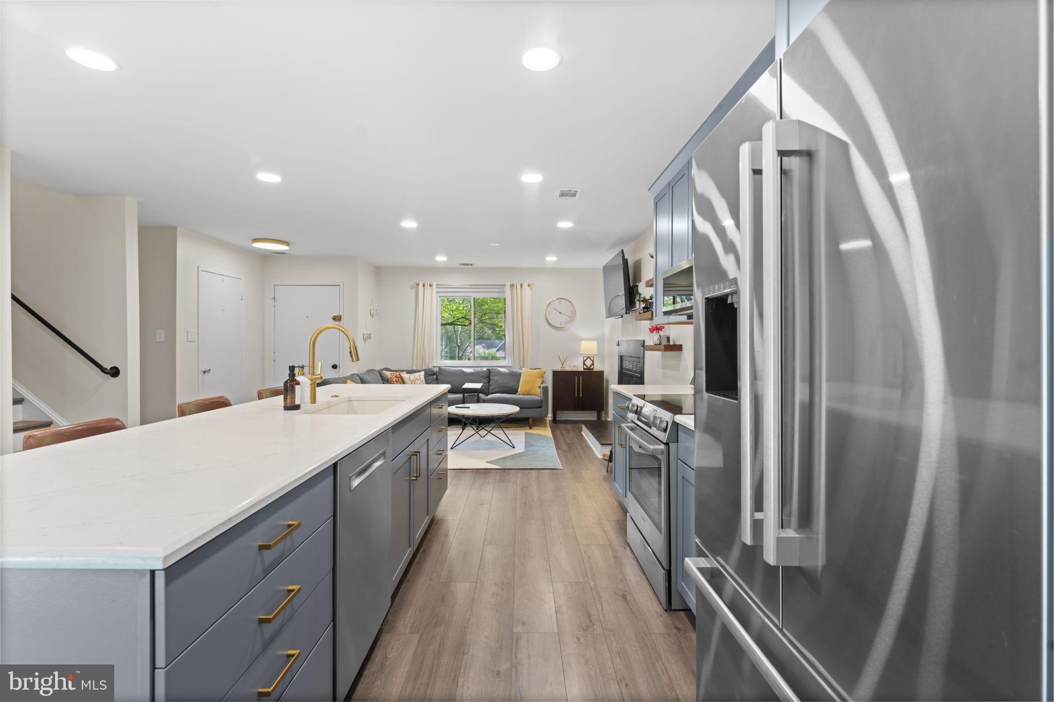 11308 Gatesborough Lane Reston, VA 20191 - Photo 9 of 58 a kitchen with stainless steel appliances granite countertop a refrigerator and a sink