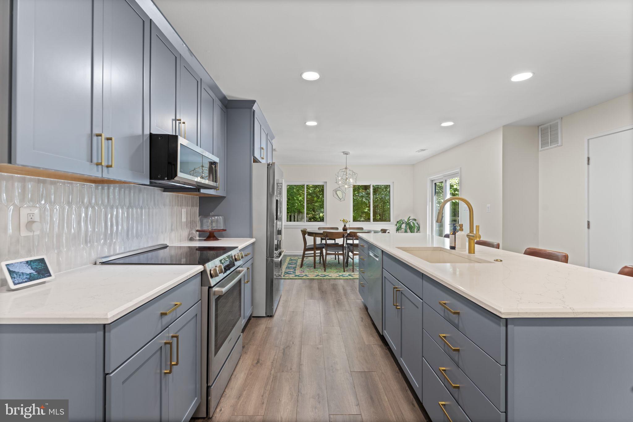 11308 Gatesborough Lane Reston, VA 20191 - Photo 10 of 58 a kitchen with a sink stove and cabinets