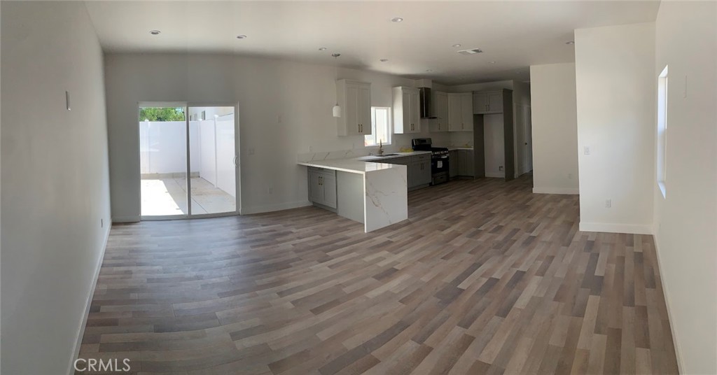 a kitchen with a refrigerator and a stove top oven