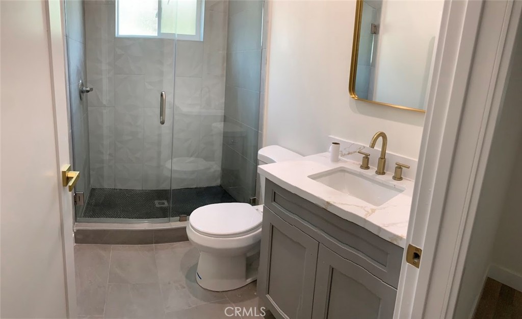 19509 Enadia Way Reseda, CA 91335 - Photo 11 of 15 a bathroom with a sink toilet and shower