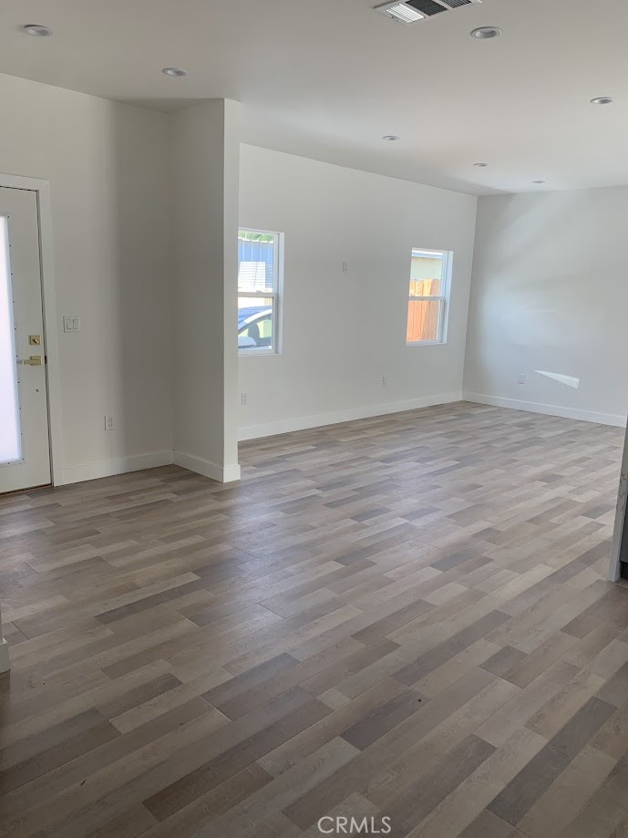 19509 Enadia Way Reseda, CA 91335 - Photo 13 of 15 an empty room with wooden floor and windows