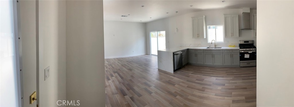 19509 Enadia Way Reseda, CA 91335 - Photo 9 of 15 a view of a kitchen with wooden floor and electronic appliances