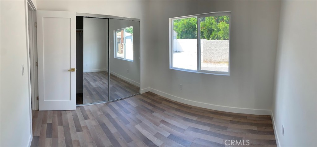 19509 Enadia Way Reseda, CA 91335 - Photo 10 of 15 an empty room with wooden floor and windows
