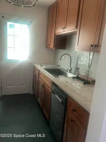a kitchen with a sink a stove and cabinets