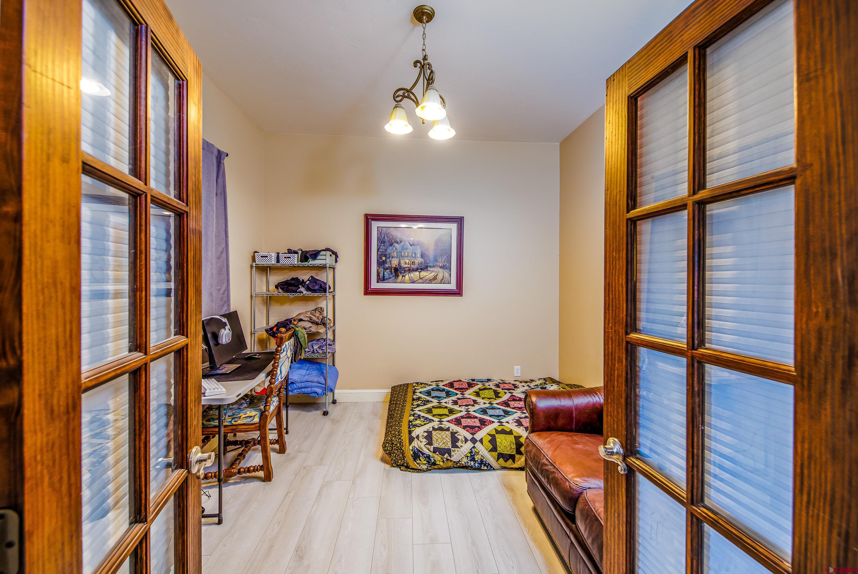 69392 Racine Road Montrose, CO 81401 - Photo 11 of 32 a bedroom with furniture and a window