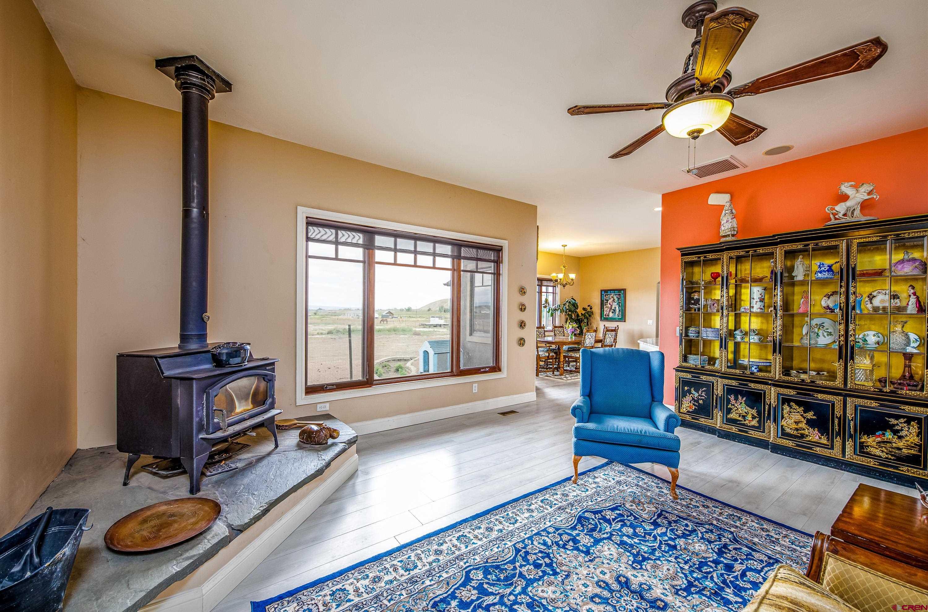 69392 Racine Road Montrose, CO 81401 - Photo 16 of 32 a living room with furniture gym equipment and a large window