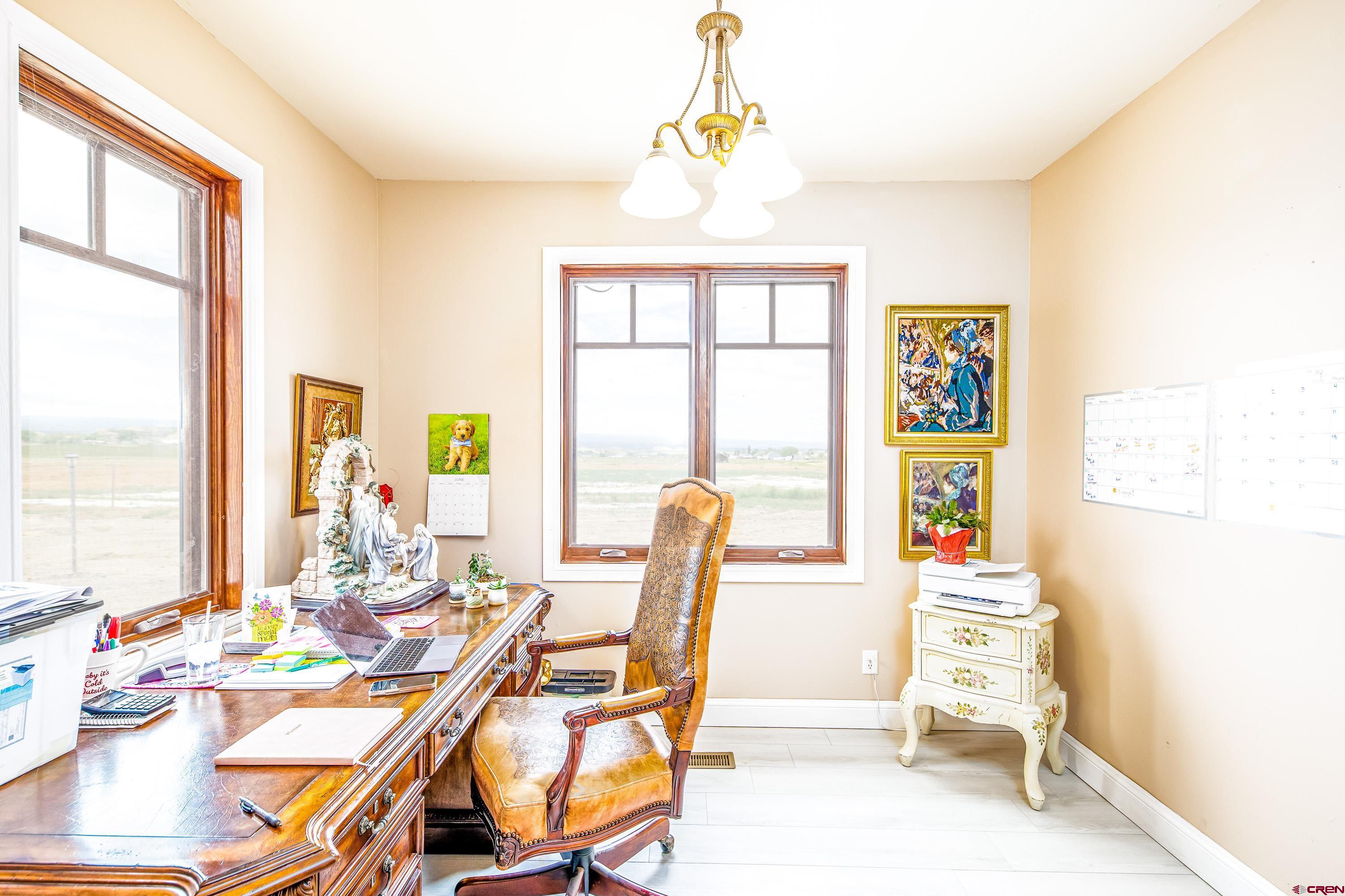 69392 Racine Road Montrose, CO 81401 - Photo 24 of 32 a dining room with furniture a chandelier and wooden floor