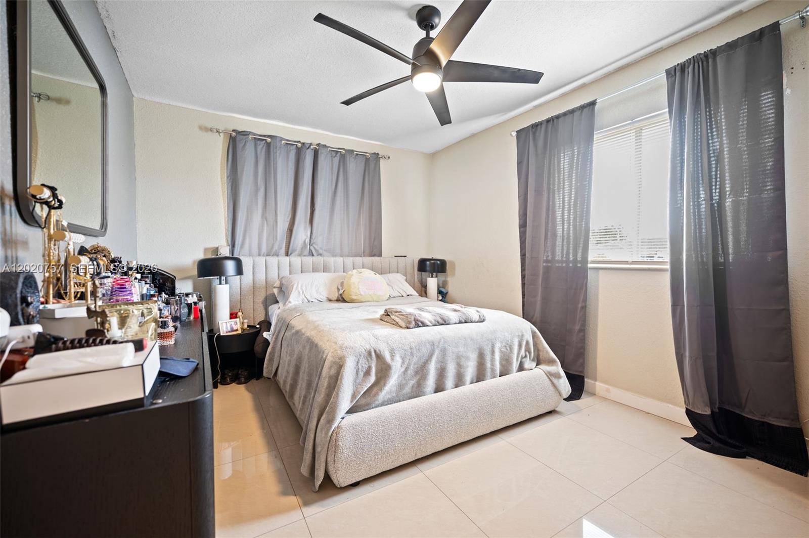 255 East 3rd Street, Unit 1 Hialeah, FL 33010 - Photo 15 of 38 a bedroom with a bed gym equipment and a window