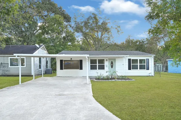 a front view of house with yard outdoor seating and barbeque oven