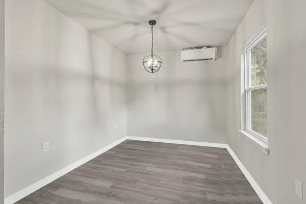 a room with wooden floor and windows