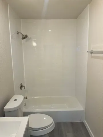 a bathroom with a toilet and shower