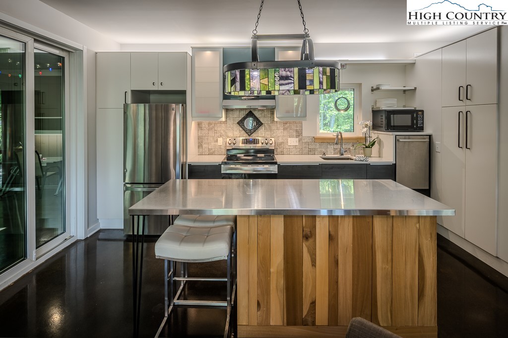 314 Hillandale Drive Boone, NC 28607 - Photo 13 of 49 a kitchen with stainless steel appliances granite countertop a sink refrigerator and cabinets