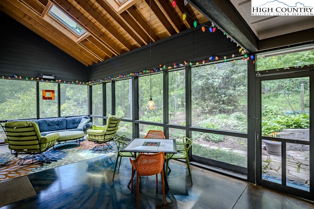 314 Hillandale Drive Boone, NC 28607 - Photo 17 of 49 a living room with furniture and floor to ceiling windows