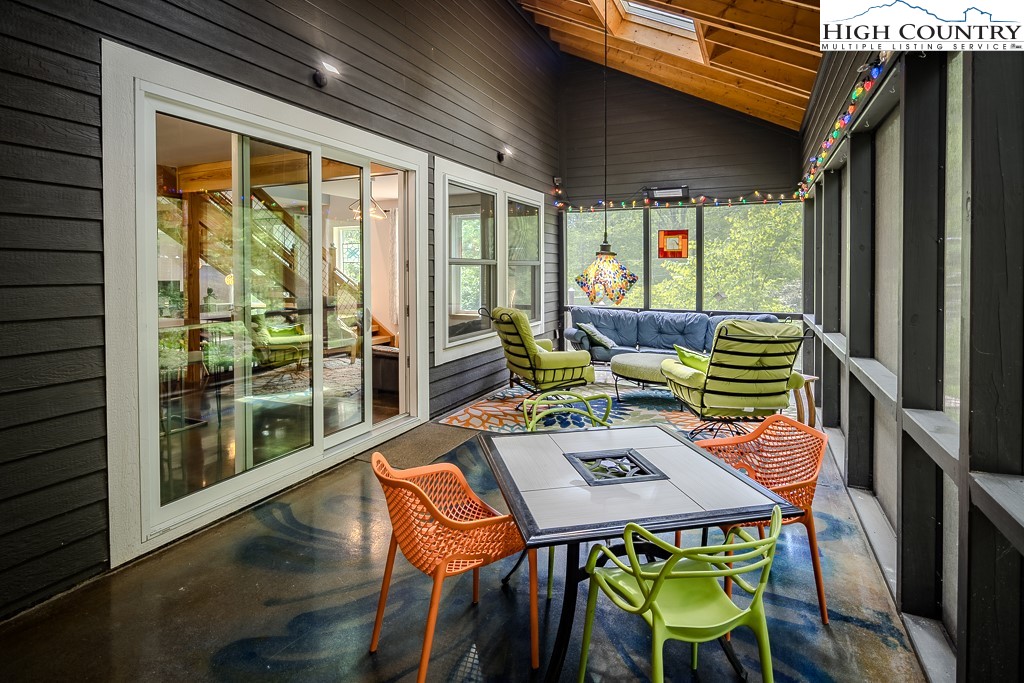 314 Hillandale Drive Boone, NC 28607 - Photo 18 of 49 a backyard of a house with wooden floor table and chairs