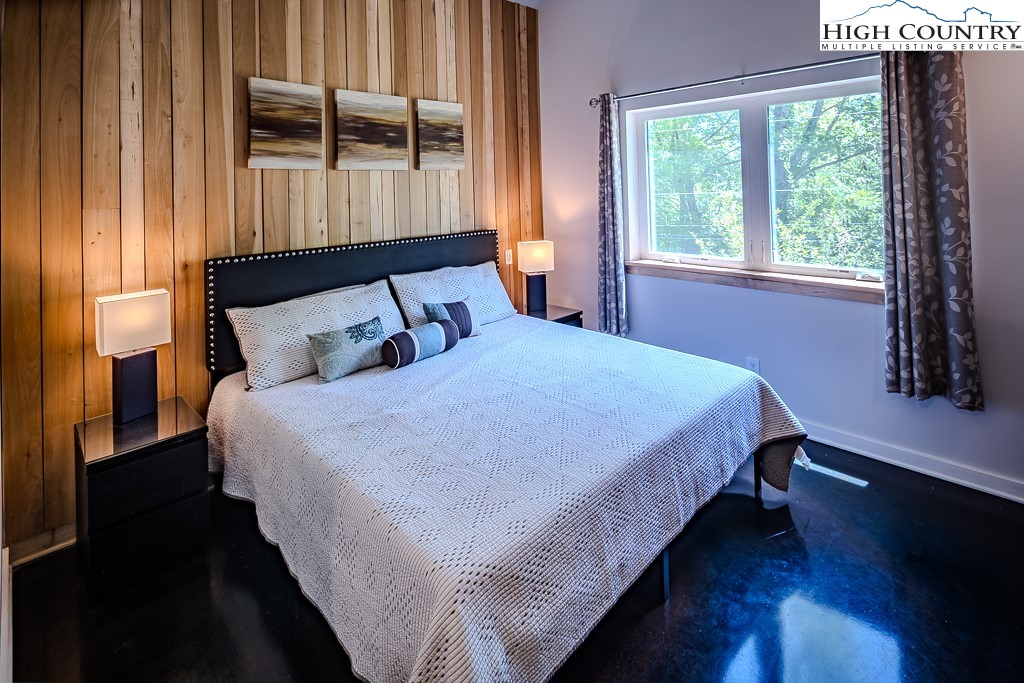 314 Hillandale Drive Boone, NC 28607 - Photo 25 of 49 a bedroom with a bed window and wooden floor