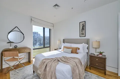 a bedroom with a bed and a mirror