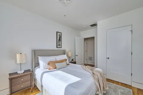 a bedroom with a bed and a night stand