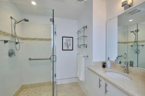 a bathroom with a shower sink and mirror
