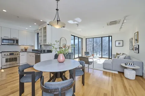 a view of a dining room with furniture window and wooden floor