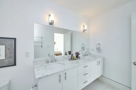 a bathroom with a double vanity sink and a mirror