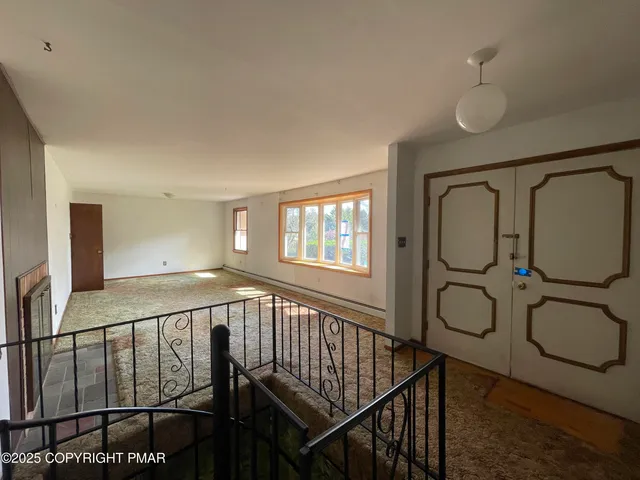a view of entryway with a window and wooden floor