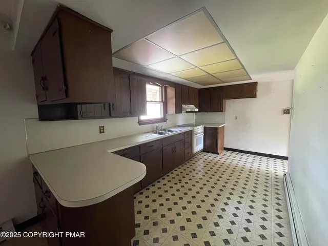 a kitchen with a sink a stove a refrigerator and cabinets