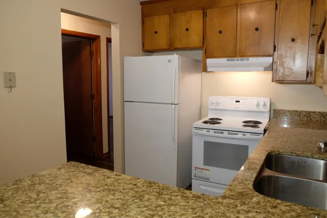 a kitchen with a refrigerator stove and cabinets