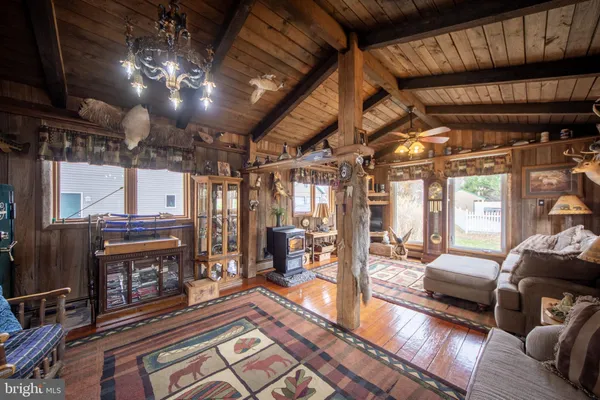 a bedroom with a bed with wooden floor and furniture