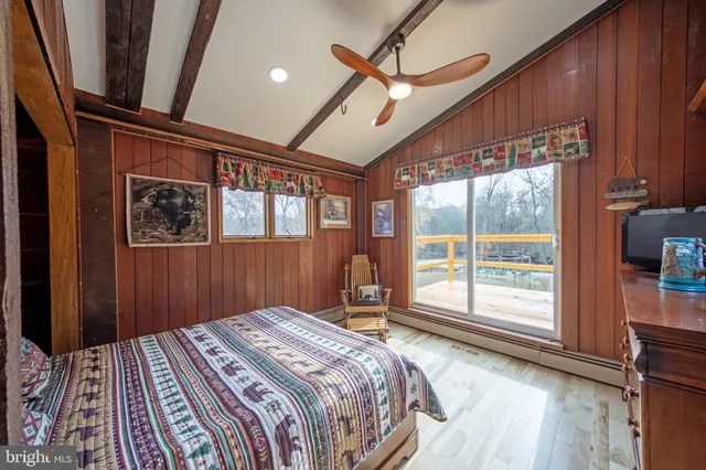 a view of a swimming pool with a patio and fire pit