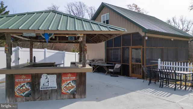 an aerial view of residential houses with outdoor space and trees