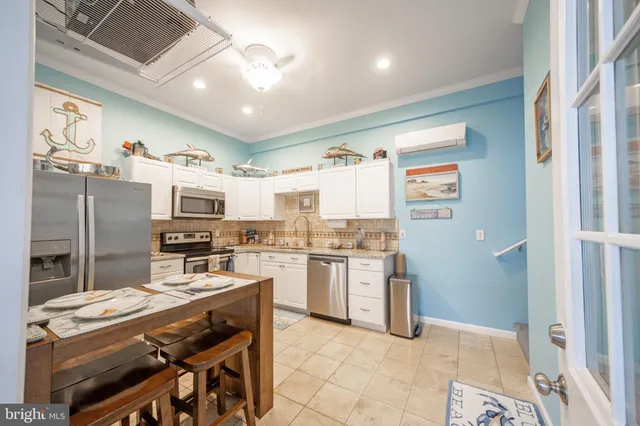 a kitchen with stainless steel appliances granite countertop a sink stove refrigerator and cabinets
