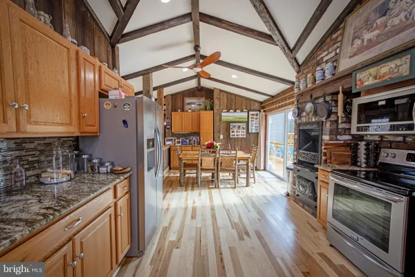 a kitchen with stainless steel appliances granite countertop a stove and a refrigerator