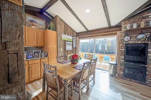 a view of a dining room with furniture a chandelier and wooden floor
