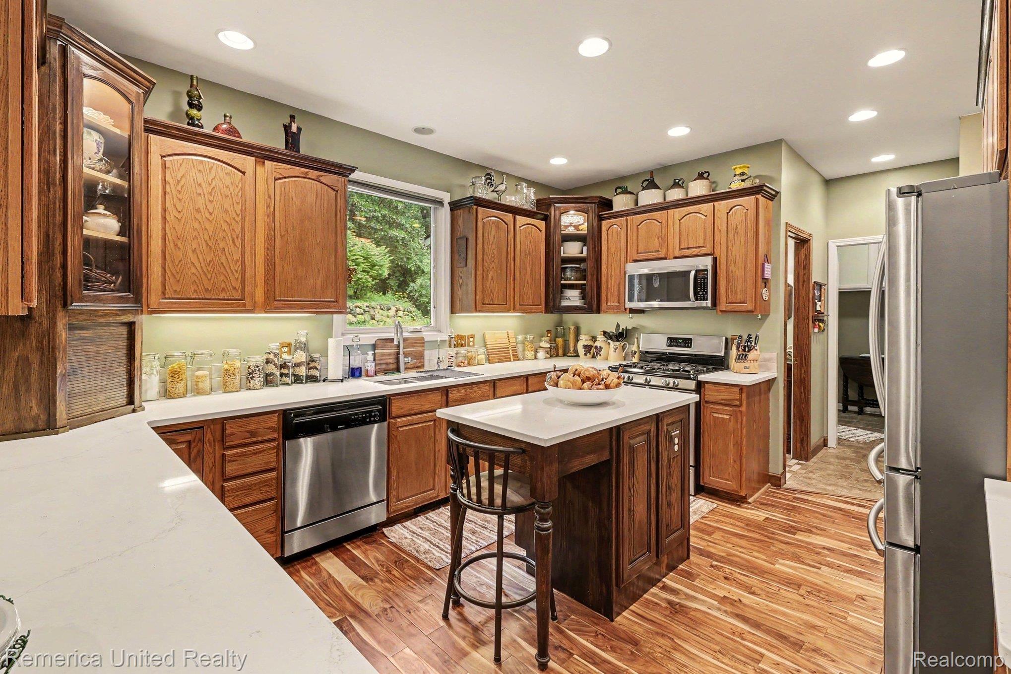 20962 Wasson Road Gregory, MI 48137 - Photo 11 of 39 Kitchen featuring wood-finish flooring, recessed lighting, and light green wall paint