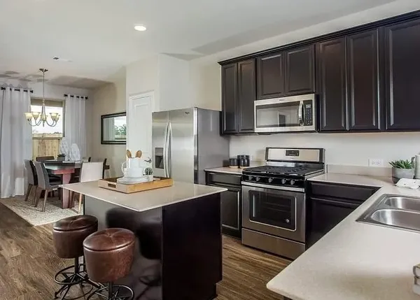 a kitchen with a stove a sink and a refrigerator