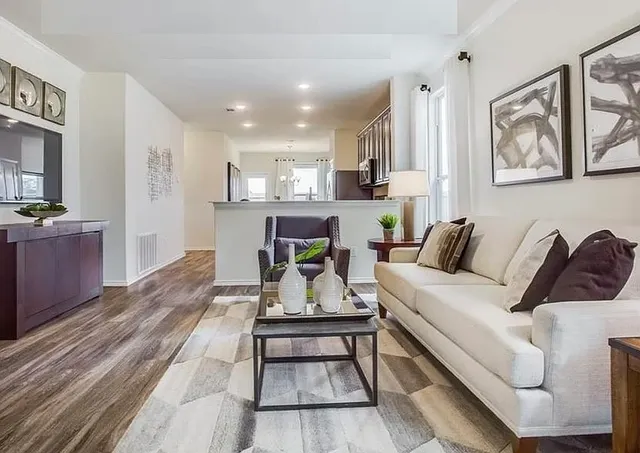 a living room with furniture kitchen view and a table