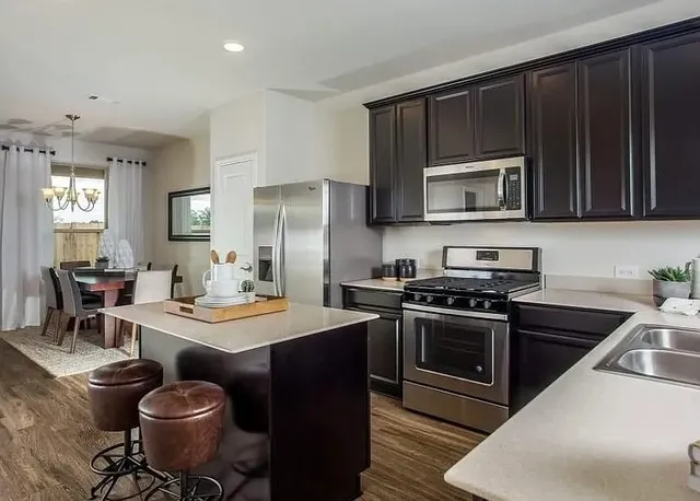a kitchen with a stove a sink and a refrigerator