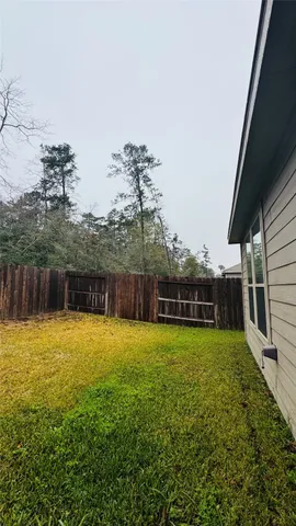 a view of a backyard with plants and lake view