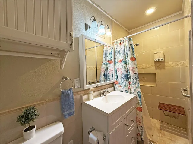 a view of house with wooden deck and backyard