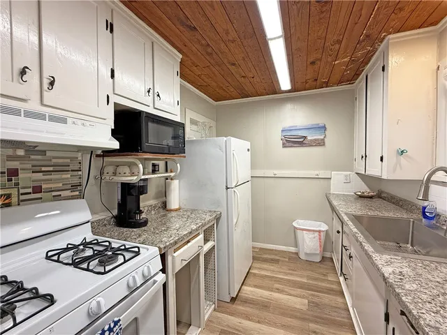 a bedroom with a bed and a table with wooden floor