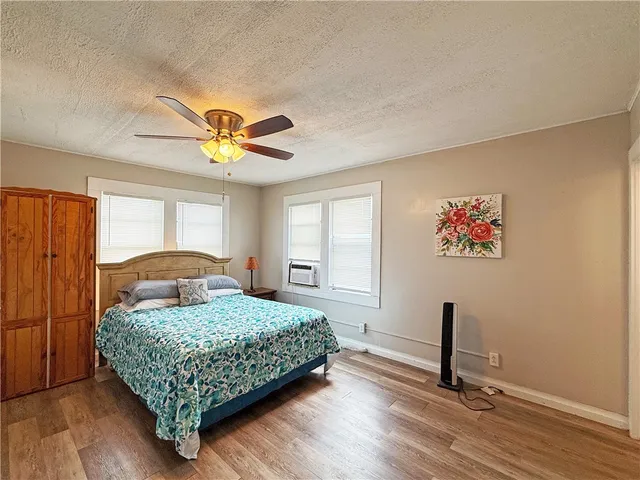 a bathroom with a granite countertop sink mirror vanity shower and toilet